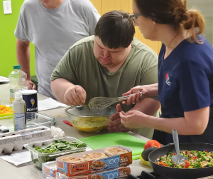 Client with down syndrome partakes in a cooking class