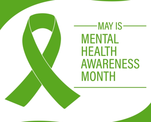 A green awareness ribbon on a white background with green borders. To the right of the ribbon, text reads: “May is Mental Health Awareness Month.”