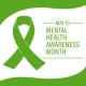 A green awareness ribbon on a white background with green borders. To the right of the ribbon, text reads: “May is Mental Health Awareness Month.”